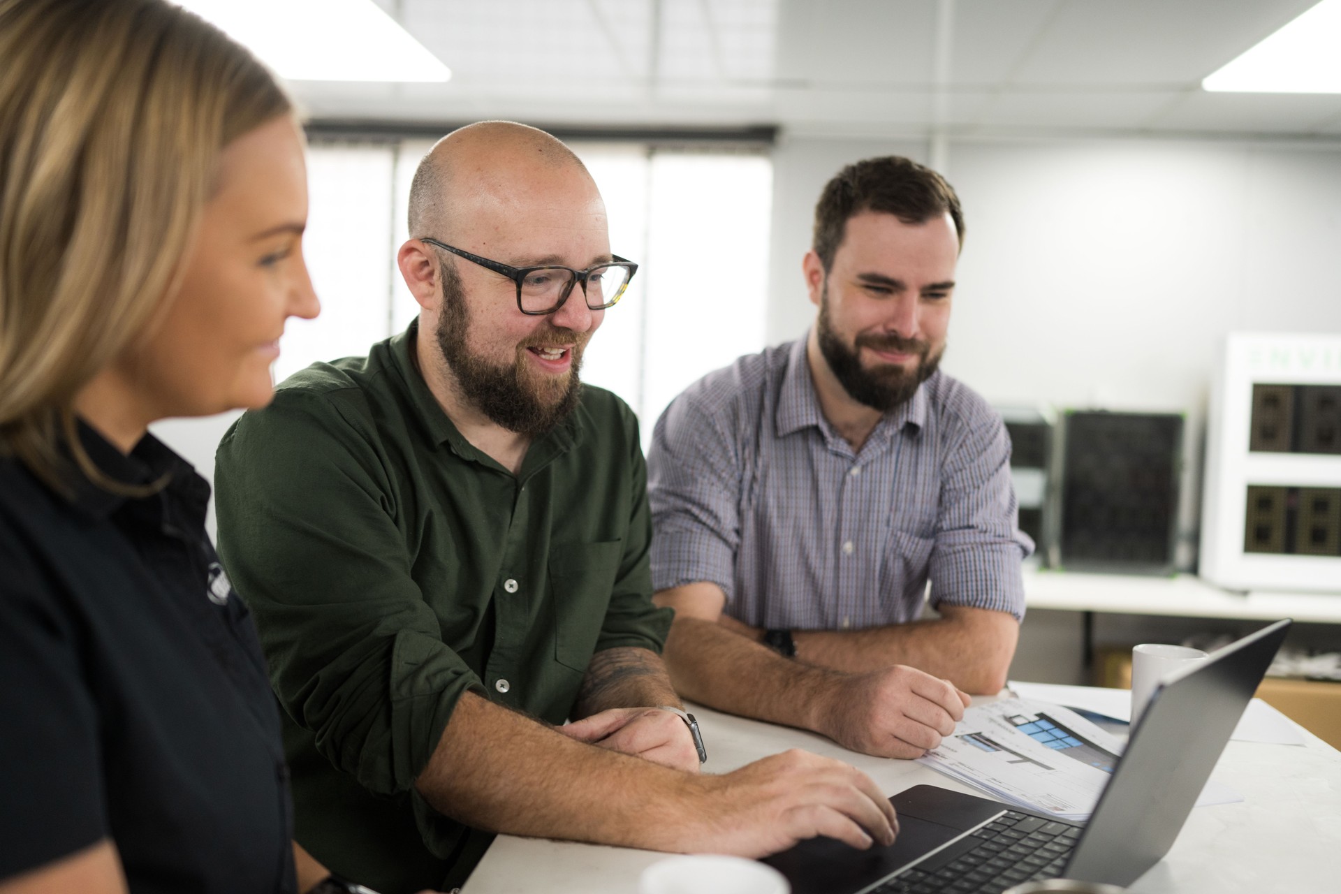 Business people working on laptop computer in modern office and analysing documents